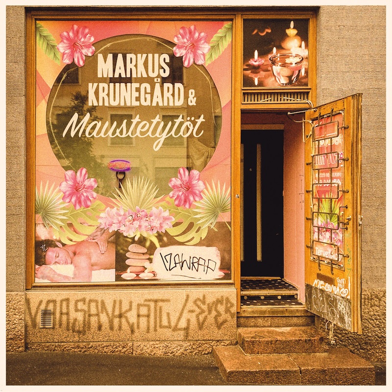 Image of urban storefront with steps leading up to an open door, a massage-parlor style window with circular transparency overlaid with the name of the artists and the title of the lead track spray painted on the concrete under the window